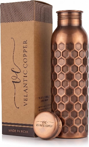 Hammered copper water bottle with honeycomb pattern beside its Velantic Copper kraft gift box and copper cap
